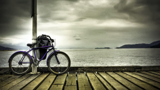 Purple bike pier ocean mountains - the ocean under a cloudy sky free wallpaper