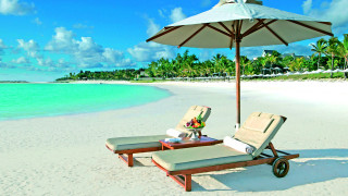 Lounge chairs beach umbrella table - luxury free wallpaper
