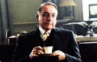 Man in suit holding coffee - american realism free wallpaper