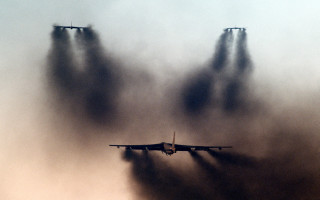 Plane flying smoke jets clouds - dusty free wallpaper