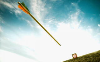 Yellow arrow flying field target - over a field free wallpaper