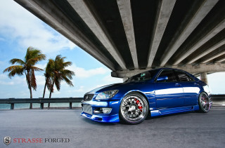 Blue car parked bridge water 2 - andrew bell free wallpaper