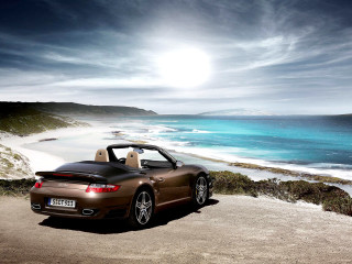 Brown sports car ocean beach - a sun free wallpaper for desktop