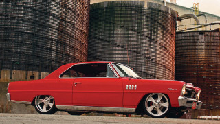 Red car barrels building clock - a red car free wallpaper