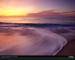 Sunset ocean wave person beach - the beach in the distance free wallpaper
