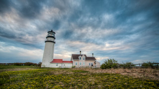 Lighthouse grassy hill cloudy sky - a grassy hill free wallpaper