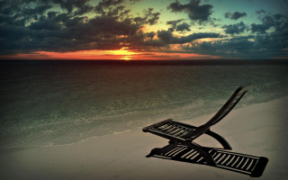 Chair sandy beach cloudy sky - sunset time free wallpaper