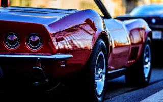 Red car parking street building - a red car free wallpaper