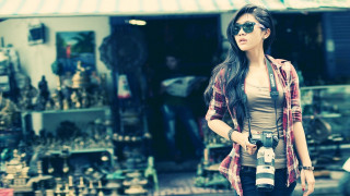 Woman holding camera store items - item free wallpaper