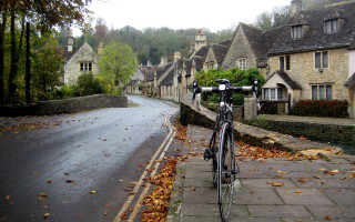 Bicycle parked road houses hill - a bicycle free wallpaper