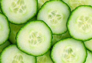 Cucumber closeup green leaves slices - half free wallpaper