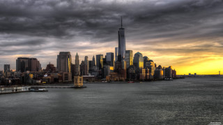 City skyline cloudy sky water - a boat in the foreground free wallpaper