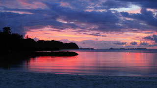 Sunset beach boat islands clouds - a sunset view of a beach free wallpaper