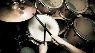 Person holding drums drum set - dynamic composition free wallpaper