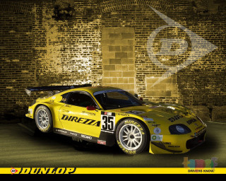 Yellow sports car brick wall - brian dunlop free wallpaper