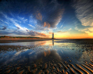 Lighthouse beach sunset clouds water 2 - a lighthouse free wallpaper