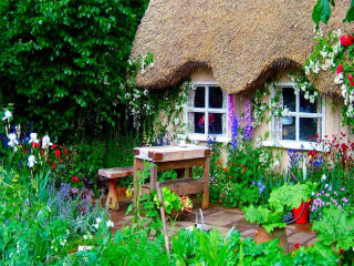 Enchanted garden thatched roof table - a garden free wallpaper
