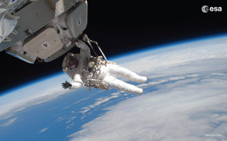 Man white space suit floating - a view of the earth free wallpaper