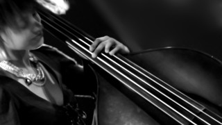Woman holding bass serious look - an ultrafine free wallpaper