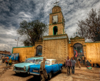 Cars parked building clock tower - a couple of cars free wallpaper