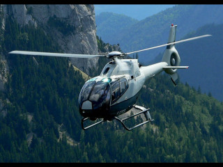 Helicopter flying mountain forest background - over a mountain free wallpaper