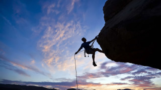 Man climbing cliff rope sunset - extreme free wallpaper
