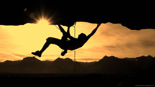 Man hanging rope climbing mountain - sunset time free wallpaper