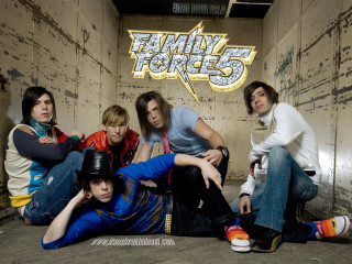 Young people sitting room graffiti - the wall behind them free wallpaper