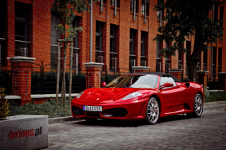 Red sports car brick street - f 8 aperture free wallpaper