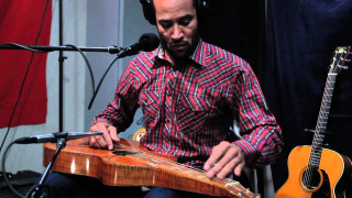 Man sitting microphone guitar headphones - chafik charobim free wallpaper