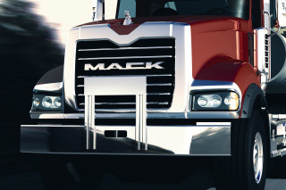 Red mack truck driving street - anson maddock free wallpaper
