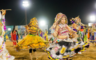 Colorful costumes dancing night field - vibrant colour free wallpaper