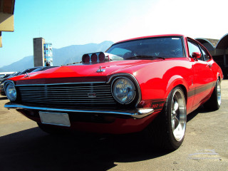 Red car parking lot mountain - free retro wallpaper