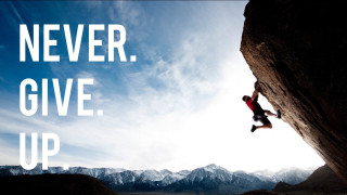 Man climbing mountain never give - a quote above free wallpaper