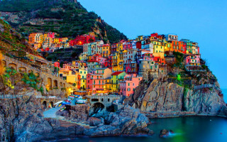 Colorful village cliff water night - vibrant color free wallpaper