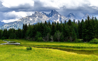 Grassy field stream mountains clouds 3 - a stream free wallpaper