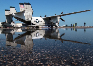 Plane parked water people standing - a few person free wallpaper