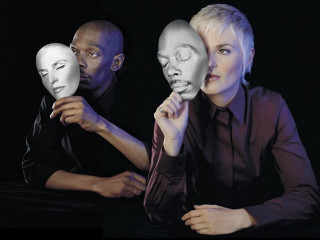 Woman men masks camera black - a black background behind them free wallpaper