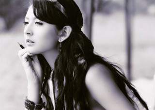 Woman long hair smoking cigarette - the side with free wallpaper