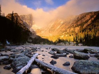 River rocks trees mountains clouds - the background and a mountain range in the distance free wallpaper