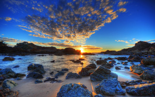 Sunset rocky beach water foreground - a sunset over a rocky beach free wallpaper