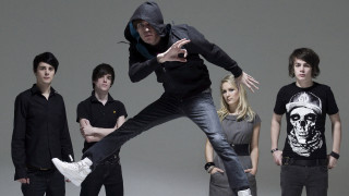 Man jumping arms out between - two other man free wallpaper