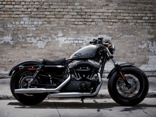 Black motorcycle brick wall building 2 - a brick wall behind free wallpaper