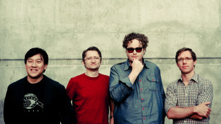 Three men standing wall clock - dan frazier free wallpaper