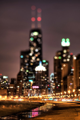 City skyline night lights reflection - a tilt shift photo free wallpaper for mobile