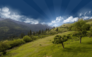 Green field trees mountains blue - cloud and sun rays free wallpaper