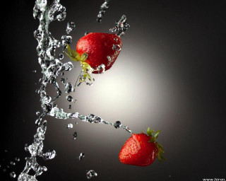 Strawberries falling water splash light - behind them free wallpaper