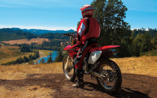 Man red jacket red motorcycle - a lake and mountains free wallpaper