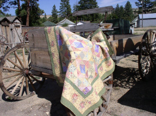 Quilted blanket draped wagon wooden - back free wallpaper