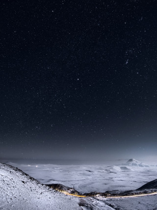 Snowy mountain road night sky - under free wallpaper for mobile